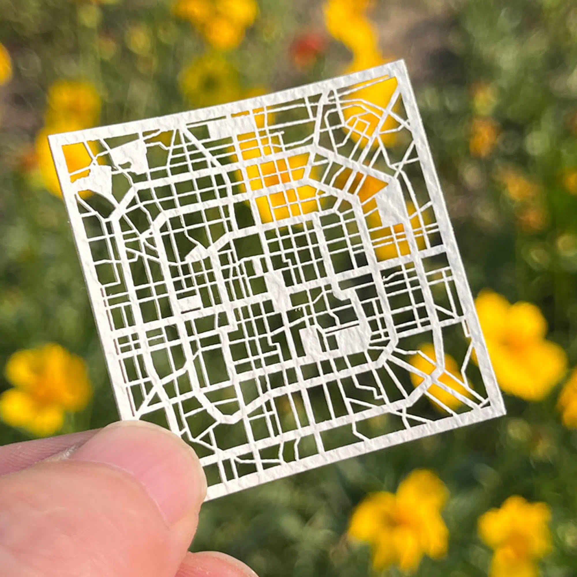 Close-up of Beijing city map paper cut artwork, intricate hollow street map cutout, unique travel souvenir